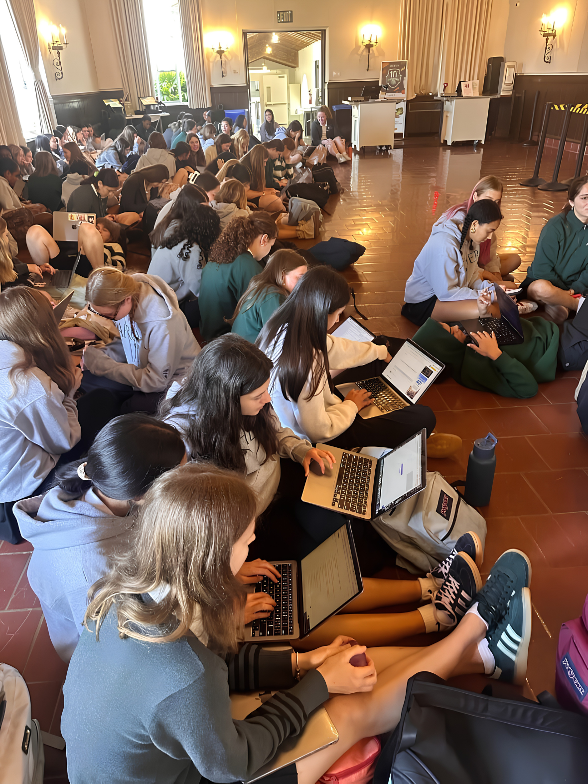 Students working together on laptops during an AI Youth Alliance workshop.